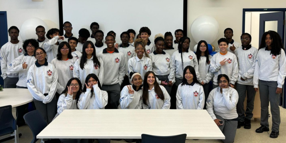 A group photo of students in their uniforms while in a classroom. 