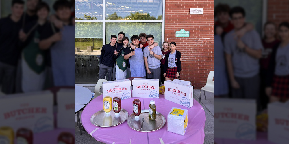 Photo of Redmond students holding the hotdog sale
