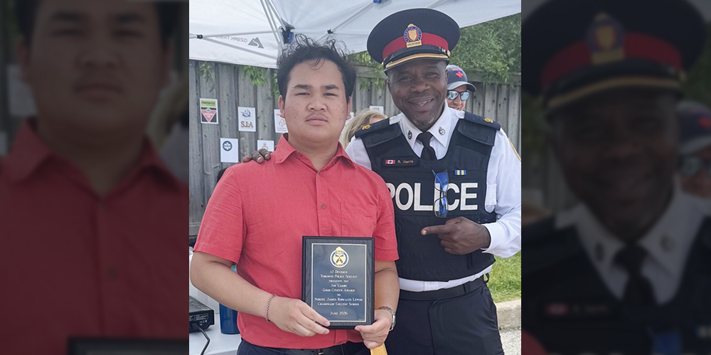 Photo of Noriel receiving his plaque from a Toronto Police Services officer