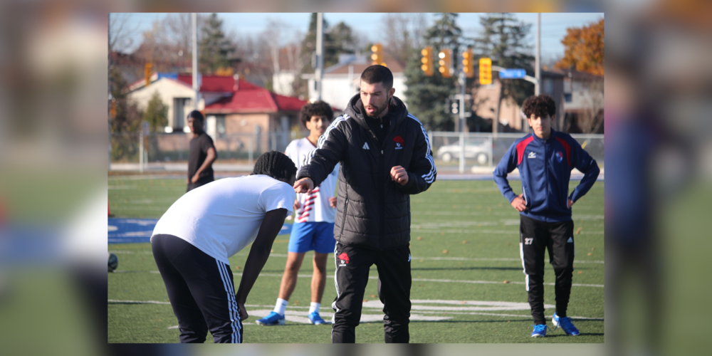 Students playing soccer outdoors.