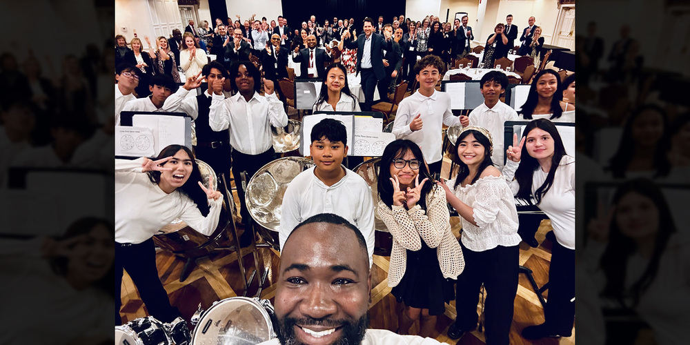 Group photo of Holy Spirit Catholic School's Steel Orchestra students along with their teachers and gala attendees