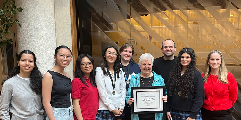 Photo of Loretty Abbey students, staff and alumni with the award