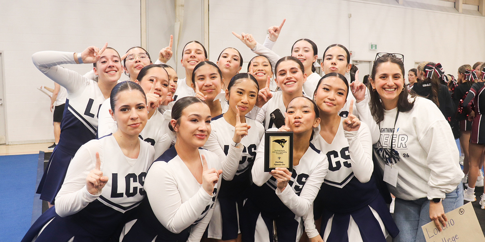 Group photo of the Loretto College cheer team with their award