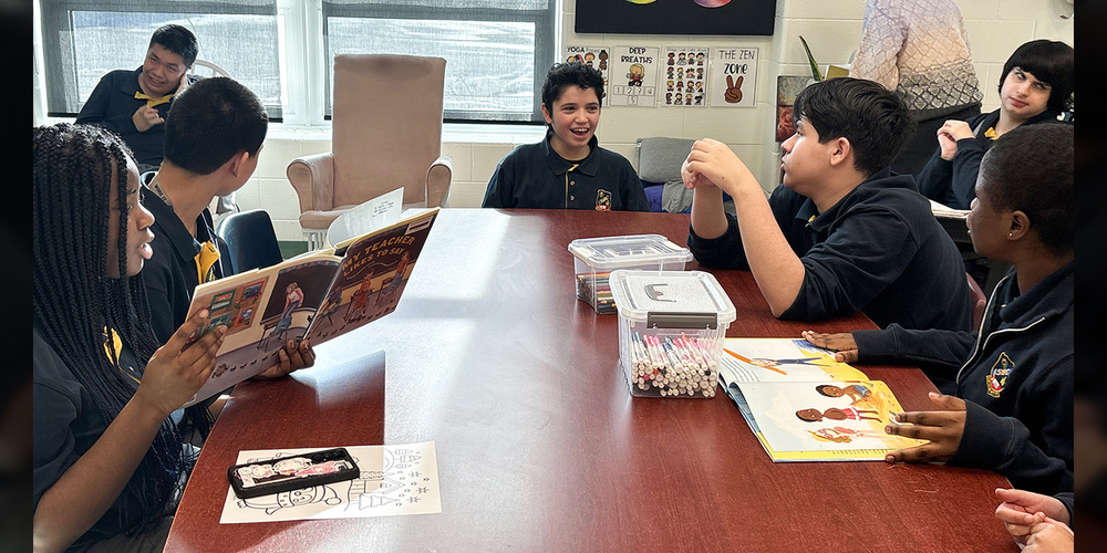 Photo of students reading together and conversing during the program