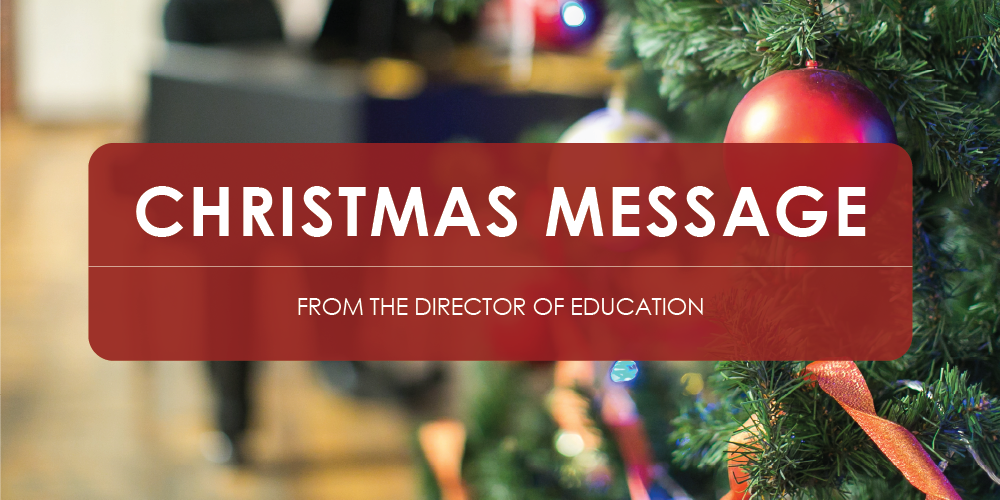 Close-up of a decorated Christmas tree with green needles, a large red ornament, and ribbon. A red banner across the image reads 'Christmas Message from the Director of Education'.