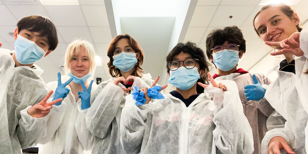 Photo of McLuhan students in lab scrubs, masks and gloves during the excursion