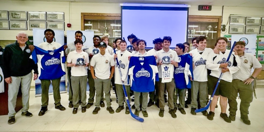 Photo of Chaminade students holding up new hockey shirts and equipment