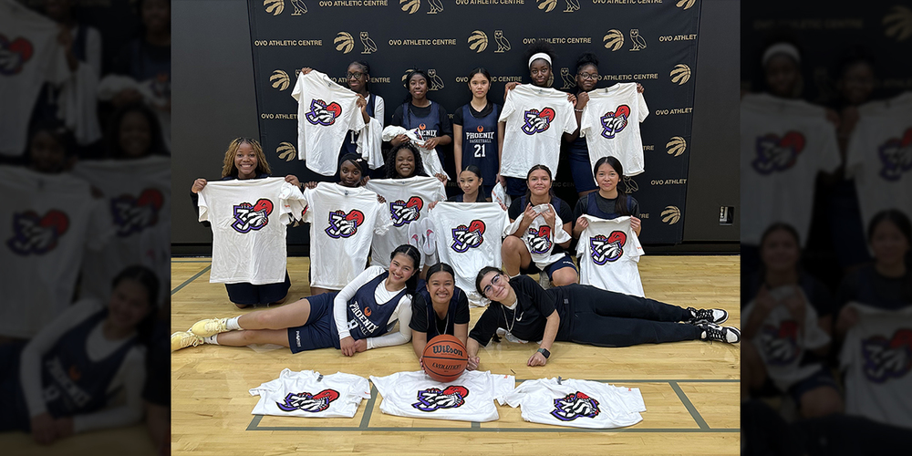 Group photo of Madonna varsity basketball team members holding up their new Raptors t-shirts