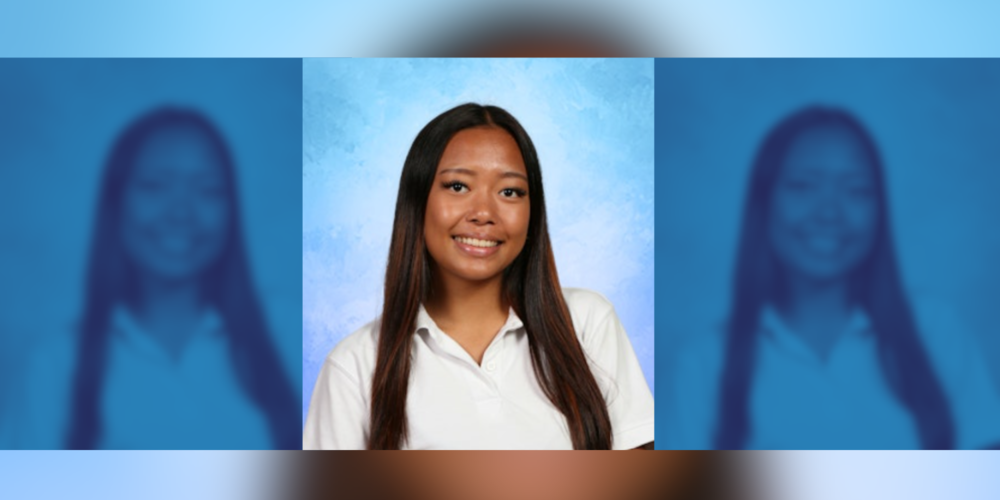 image of a girl in a white polo shirt, posing for school photos.