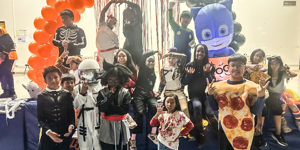 Group photo of St. Barnabas students posing in their Halloween costumes
