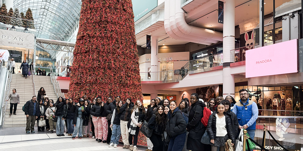 Group photo of Madonna students at the Eaton's Centre in front of the Christmas tree