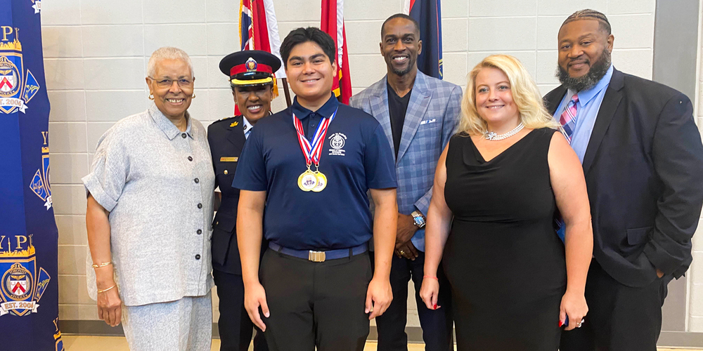 Photo of Anthony with his medals, along with Dr. Mary Ann Chambers, Toronto Police Chief Superintendent Kelly Skinner, representatives of the Jamaican Consulate, and the parliamentary assistant to MPP Lorne Coe.