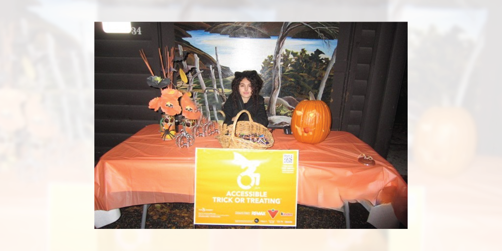 A person sitting at a table with a pumpkin and basket.