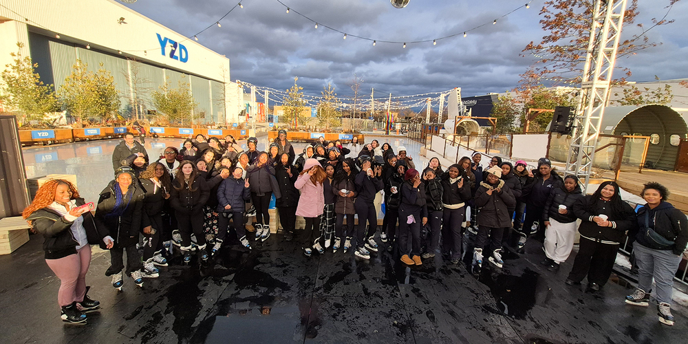 Group photo of Madonna students and staff in their skates