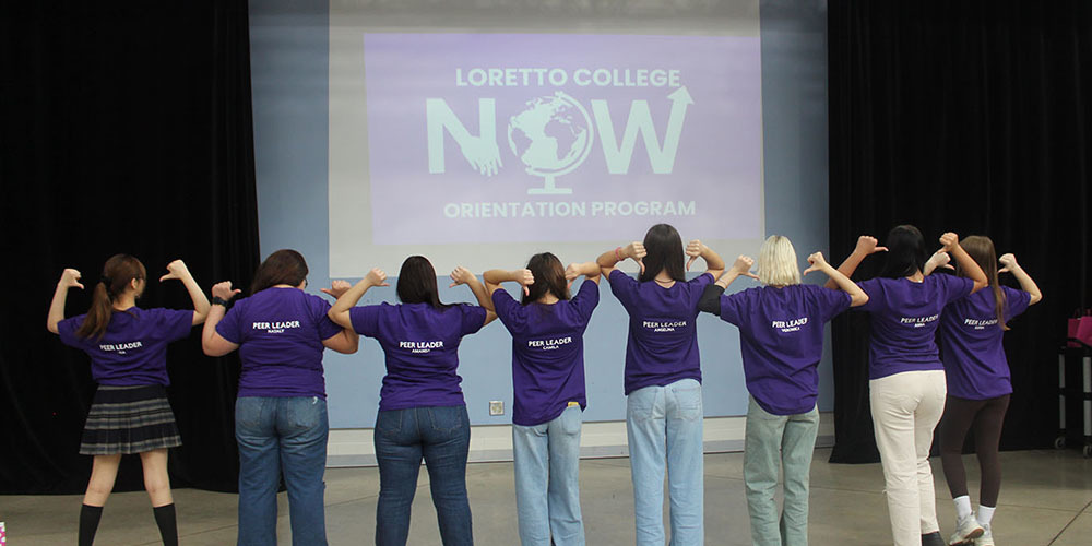 Group photo of Loretto College School ELL peer leader students wearing shirts that say Peer Leader on the back