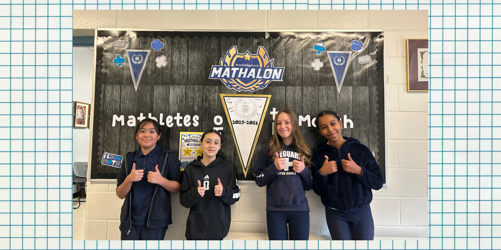 4 students posing in front of "Mathalon" banner
