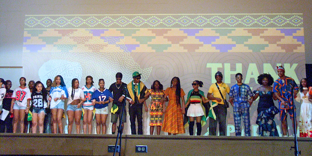 Students posing on a stage for Black History Month