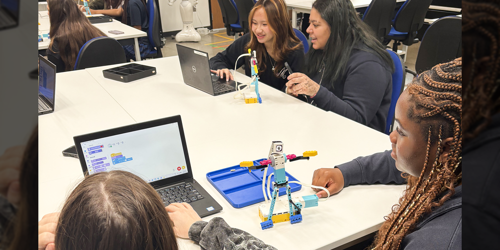 Photo of Madonna students working on coding their robots