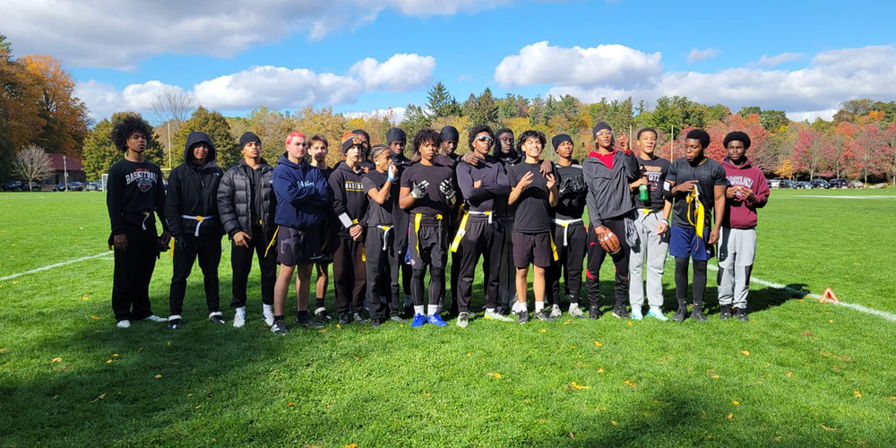 Group photo of St. John Paul II Catholic Secondary School's Senior Boys Flag Football team on the field