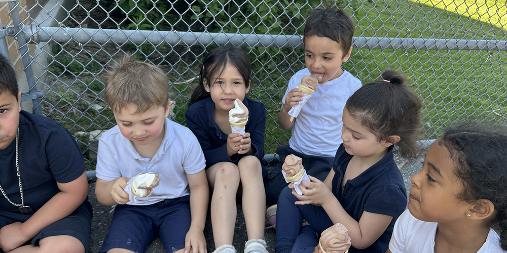 Photo of St. John Bosco students enjoying ice cream together