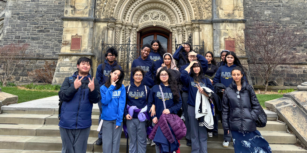 Group of students posing in front of a church.