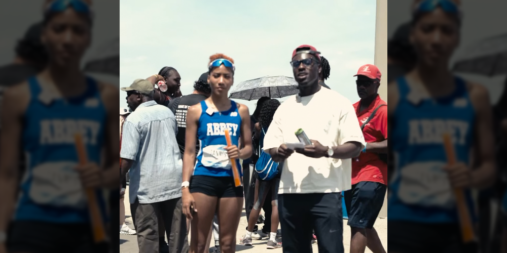 Photo of Elizabeth in her Abbey jersey, being interviewed after her record-setting spring