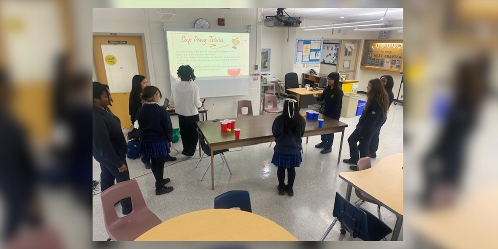 Students in a classroom looking at the projector screen.