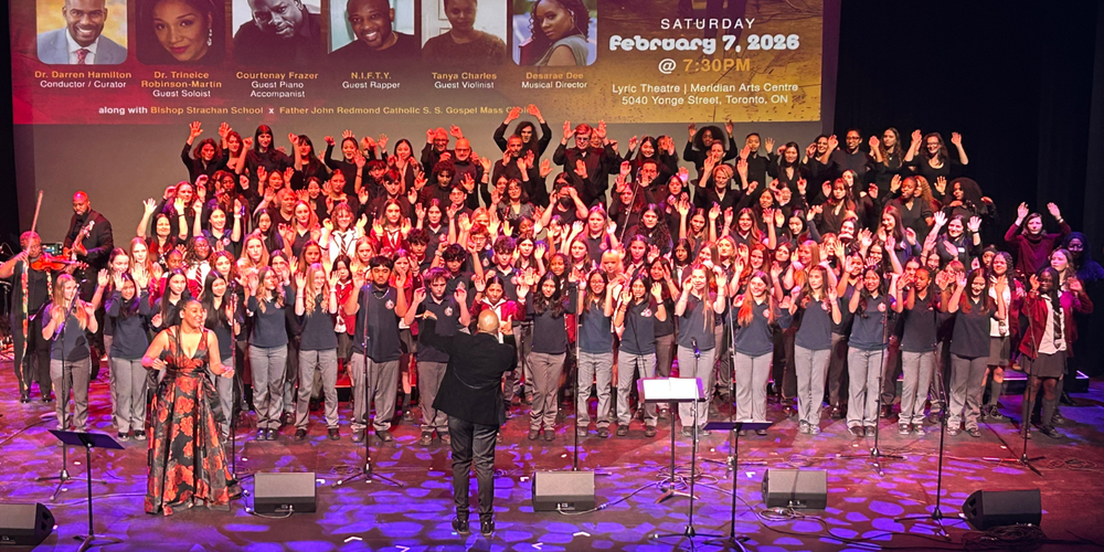 A large group of students performing music on a stage.