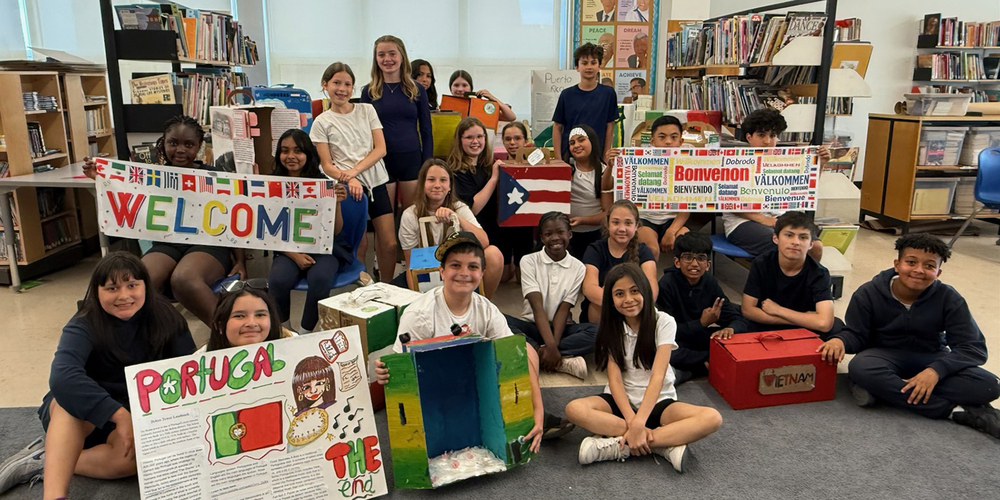Group photo of St. Benedict students with the displays they created
