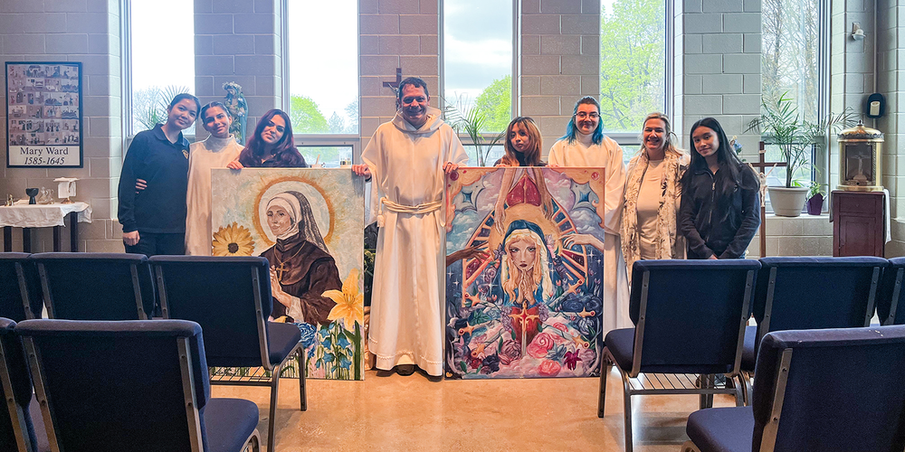 Photo of Loretto College students with Father Gustavo Campo and the two murals