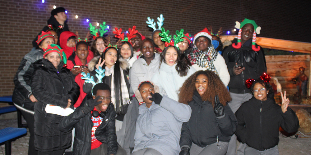 Group photo of attendees at Father Henry Carr's Christmas in the Courtyard celebration