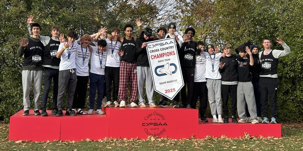 Group photo of the Neil McNeil Boys Cross Country Team with their championship medals and banner