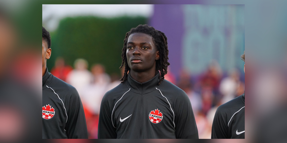 A soccer player wearing a team canada sweater.