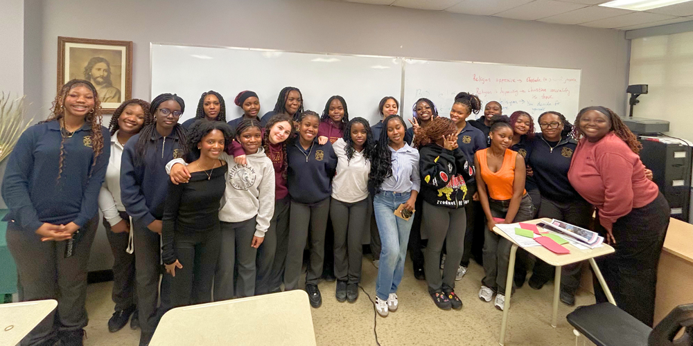 A large group of student girls in a classroom.