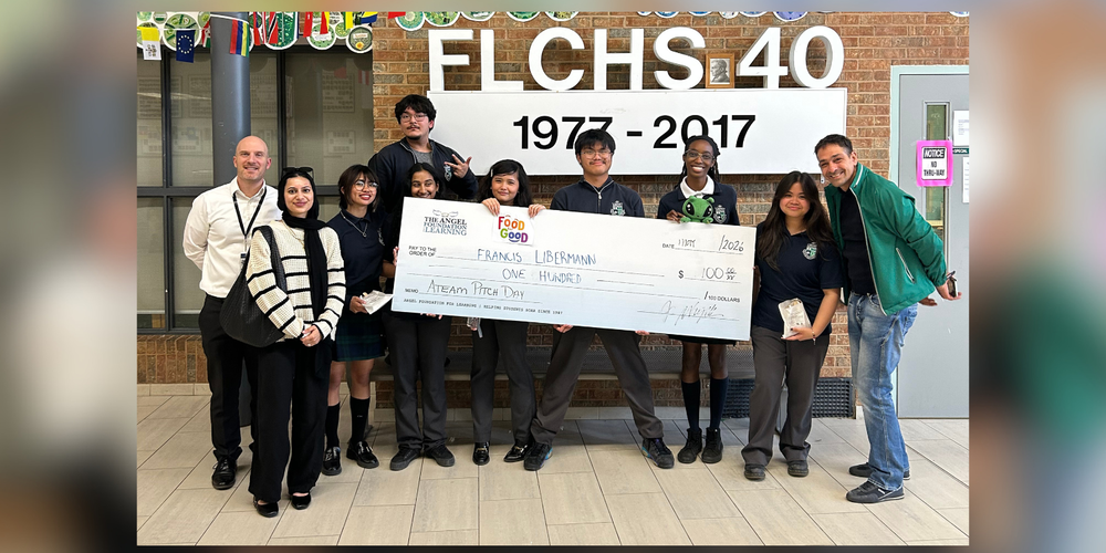 Students and faculty holding a giant cheque. 