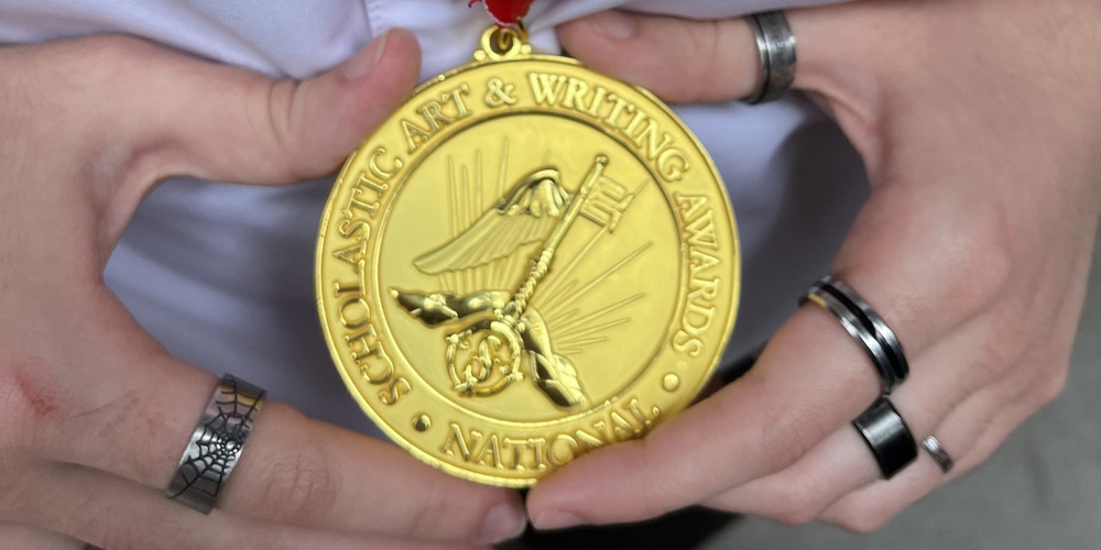 Closeup photo of Diana's hands holding her gold medal