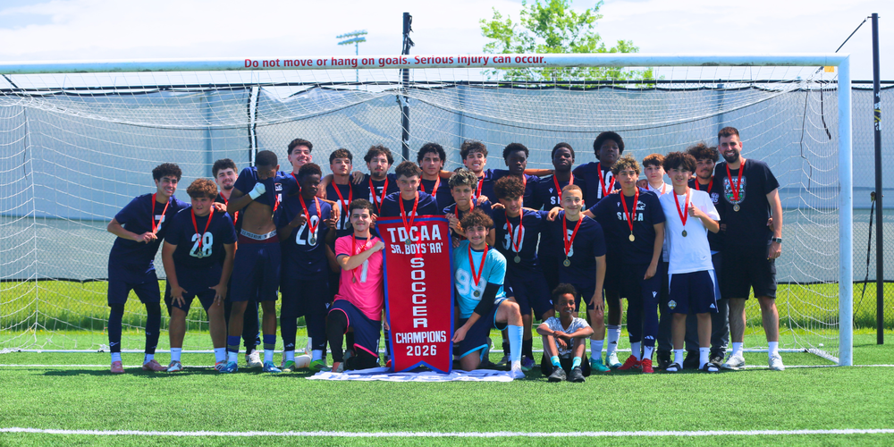 Soccer team posing with Champions Award