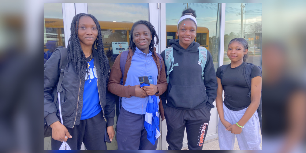 4 students posing outside. 