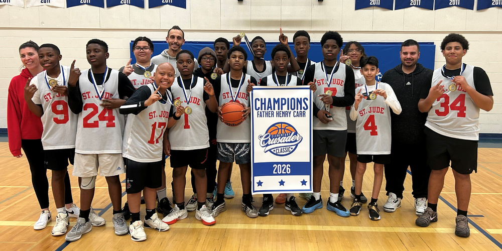 Basketball team champions posing with 2026 Champions banner