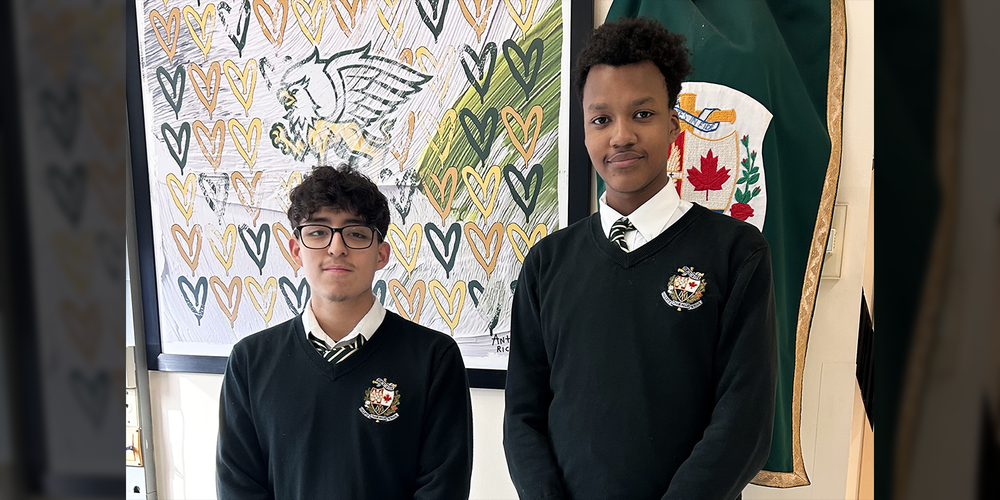 Photo of Emmanuel and Adair standing together in their Chaminade school uniforms