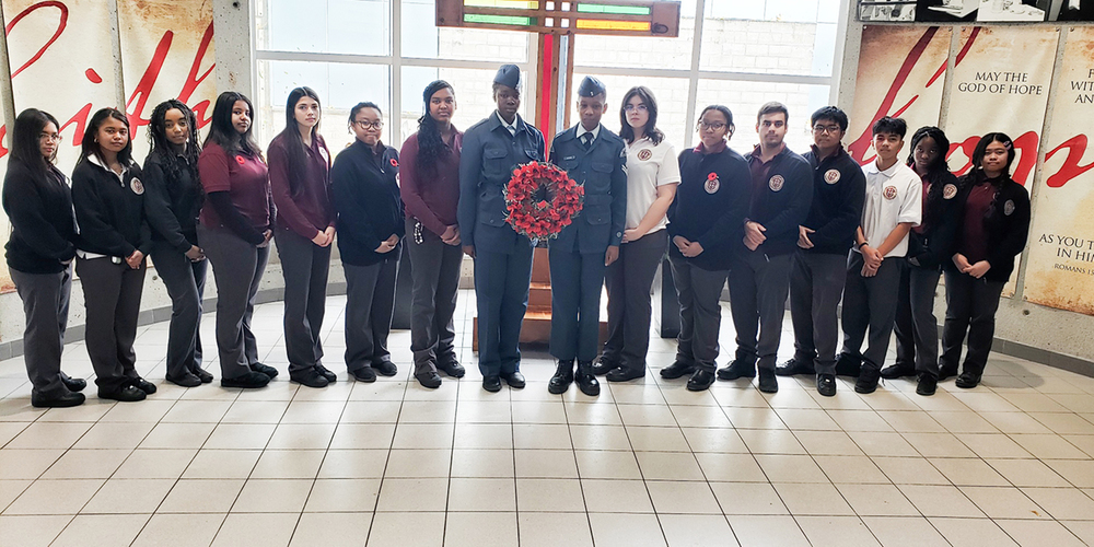 Group photo of St. Oscar Romero students, including Air Cadets, with the Remembrance Day wreath