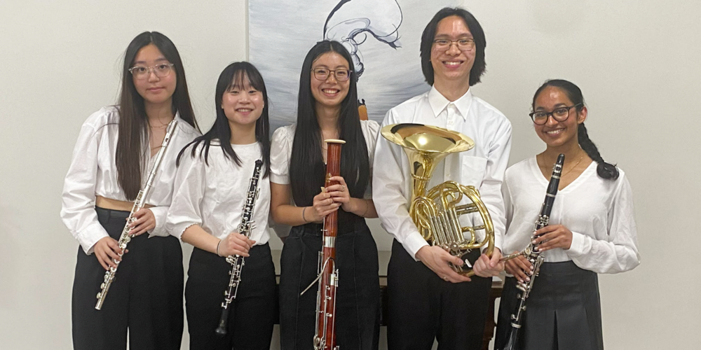 Banner - Group photo of the Cardinal Carter Senior Woodwind Quintet posing with their instruments