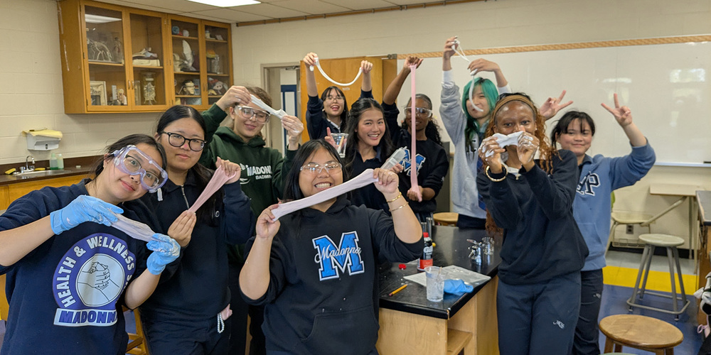 Group photo of Madonna students showing off the silly putty they made