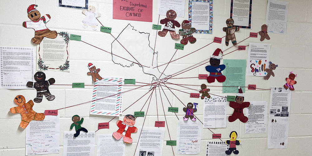 Photo of display on the wall showing all the areas of Ontario that students received gingerbread people from