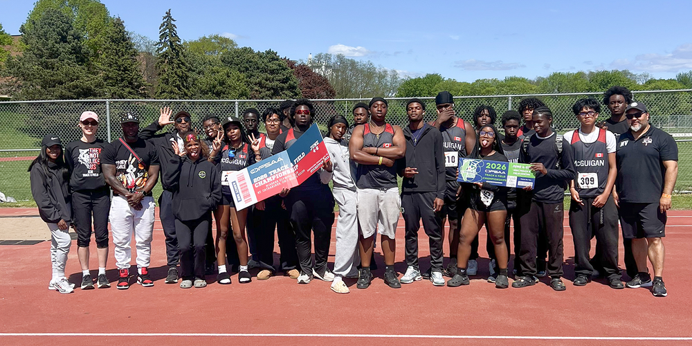 Group photo of JCM students and teachers on the field