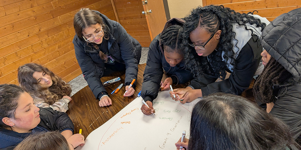 Photo of Loretto College students working together on a challenge