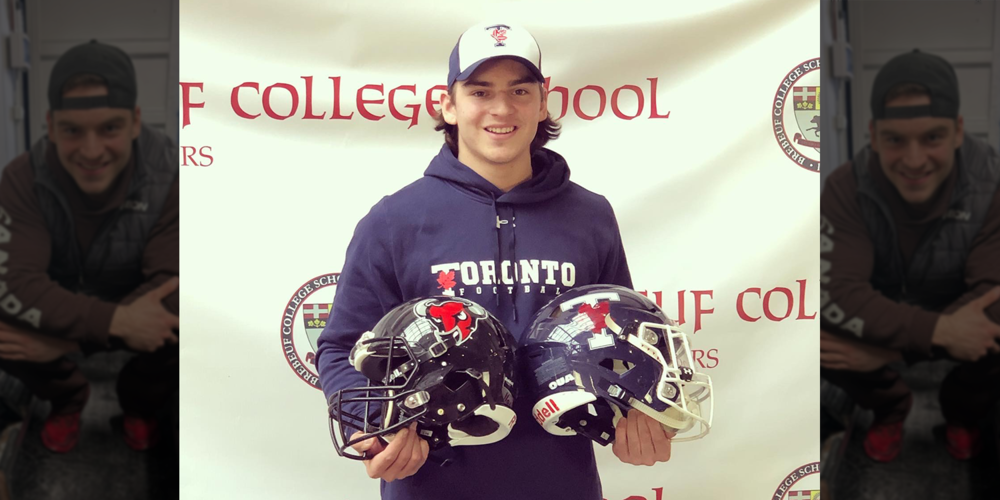 Photo of Luka holding two football helmets during his Brebeuf years