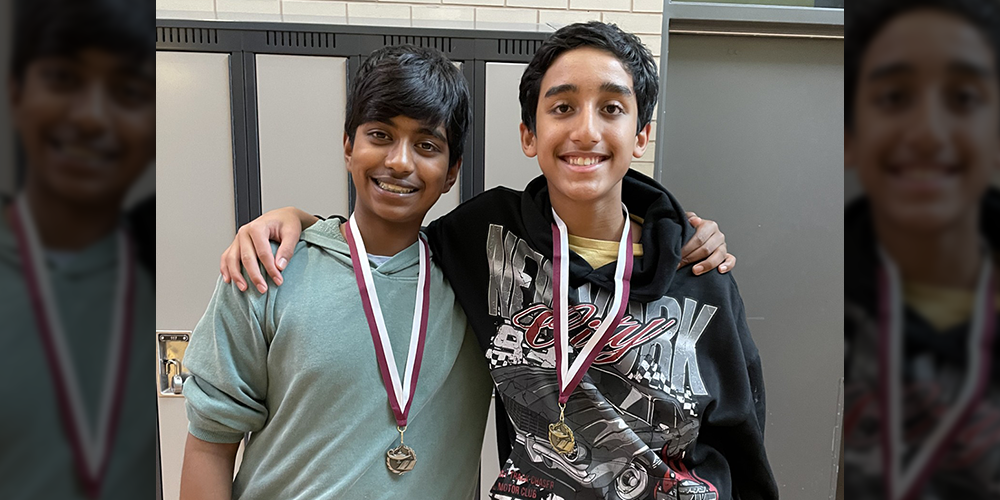 Photo of Aidan D. and Nishi S. with their medals