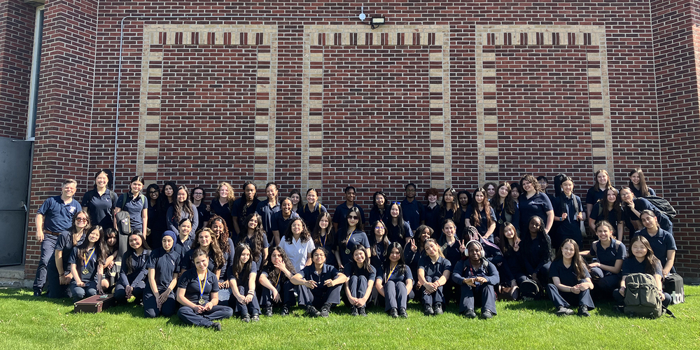 Group photo of SJCS music students in their uniforms during the excursion