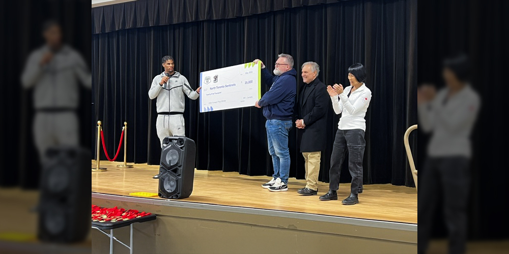 Photo of Keon Coleman and Mayor Chow during the presenting of the grant
